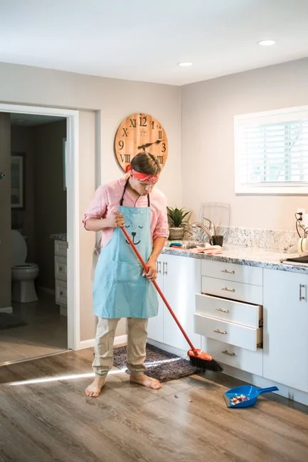 From above of crop anonymous person in rubber gloves using soapy sponge while cleaning toilet bowl